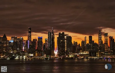 Sunrise Over New York City Skyline | A dramatic Wednesday sunrise paints Manhattan in warm gold, with city lights shimmering across the Hudson River.